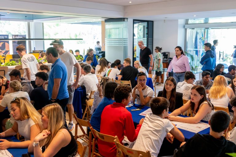 Groups of students sitting at tables, engaged in group activity.