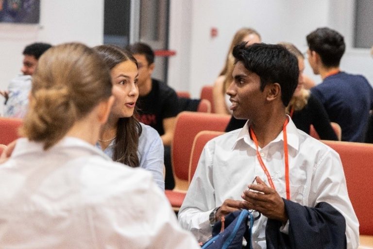 Enthusiastic students engaged in conversation.