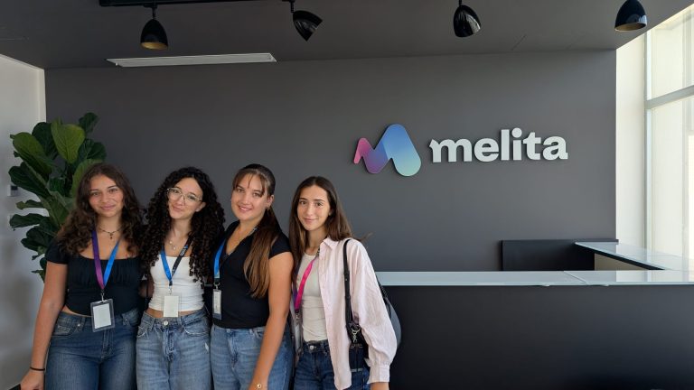 students posing in front of the Melita offices